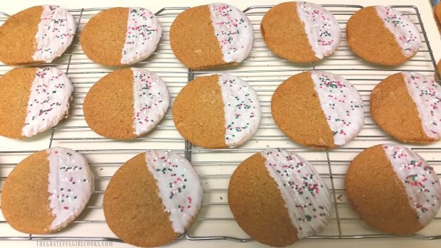 Dipped gingersnaps with sprinkles, on wire rack.
