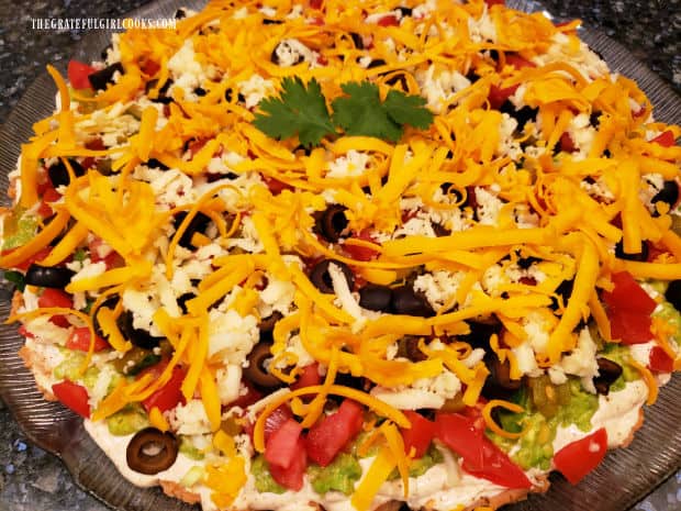 Mexican Layer Dip is chilled and is ready to serve with tortilla chips for dipping!