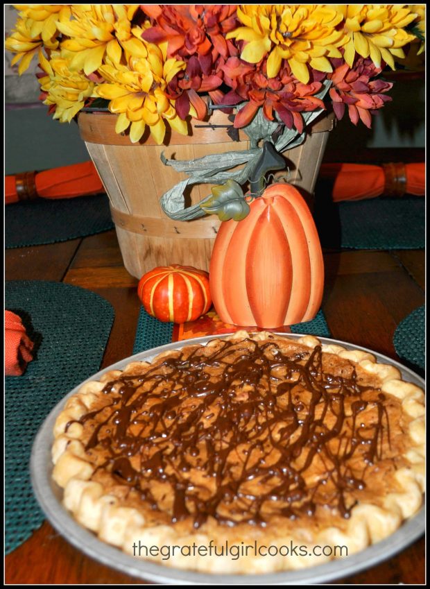 Chocolate has been drizzled all over the top of the baked pie.