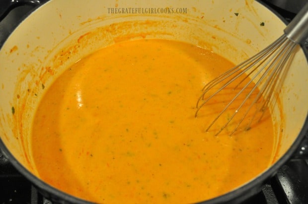 Creamy tomato basil soup, after whipping cream has been whisked in.