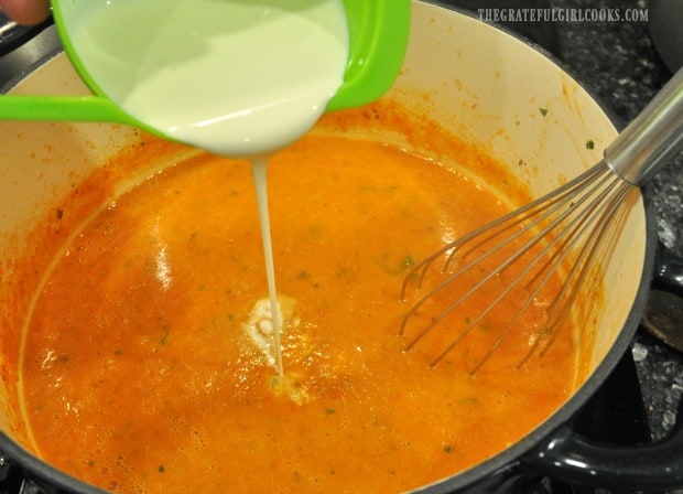 Whipping cream is added to creamy tomato basil soup.