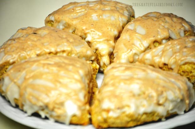 Double glazed pumpkin scones on a white plate, ready to serve!