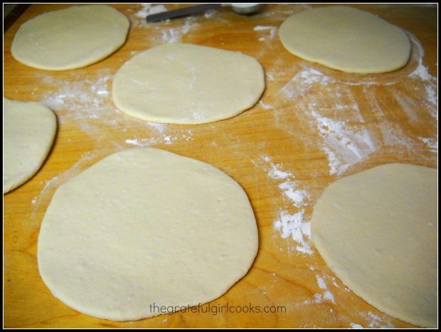 Dough for pita bread, rolled out in circles on cutting board