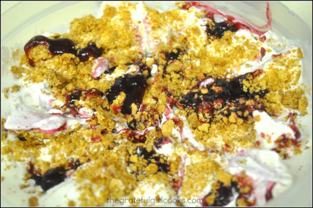 Graham crackers crumbs and blueberry topping are layered in with the ice cream.