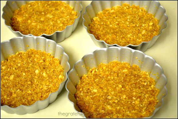Graham cracker crusts are placed in the tiny tart pans.