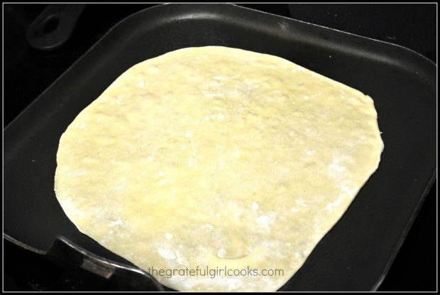 The tortillas are cooked on a hot skillet until bubbles appear on top, then they are flipped.