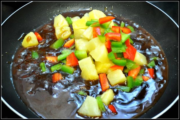 Bell peppers and pineapple are added to thickened Hawaiian meatballs stir fry sauce