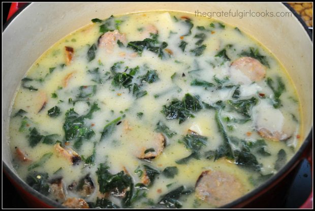 The sliced, cooked Italian sausage pieces are added to the pot of Olive Garden Toscana Soup.