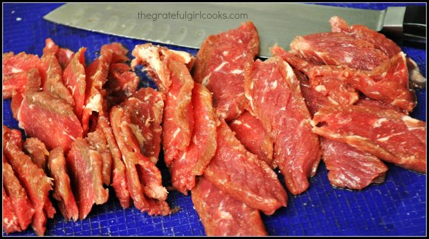 Steak is cut into thin strips for the orange beef stir fry.