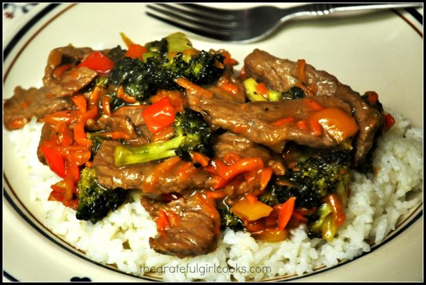 Orange Beef Stir Fry is served on top of white steamed rice.