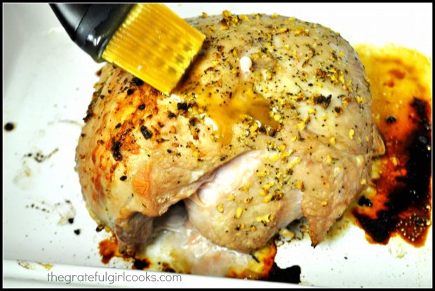 The Pork Roast being brushed with orange glaze part way through baking time.