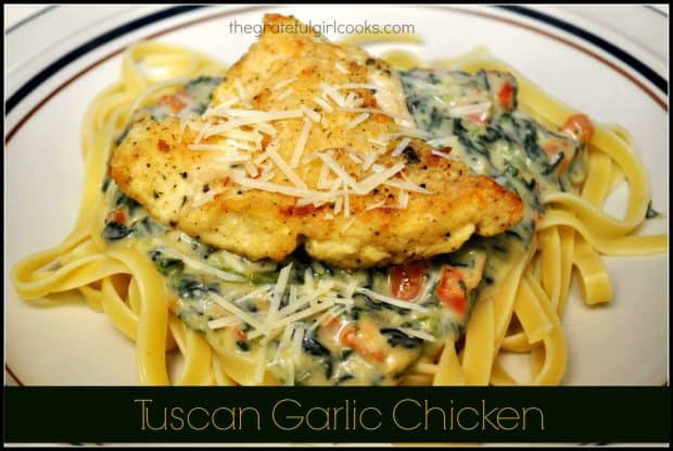 This easy, stove top Tuscan Garlic Chicken features lightly seasoned chicken, with a spinach, red pepper, garlic and Parmesan cheese sauce, on fettuccine pasta.