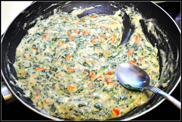 The creamy sauce for Tuscan garlic chicken is very colorful in the skillet.