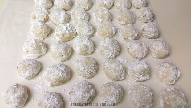 Snowball cookies, cooling on parchment paper.