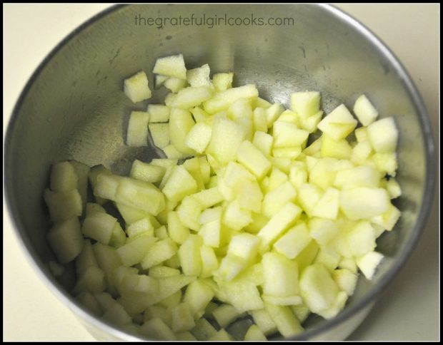 Apples are in chunks in metal bowl