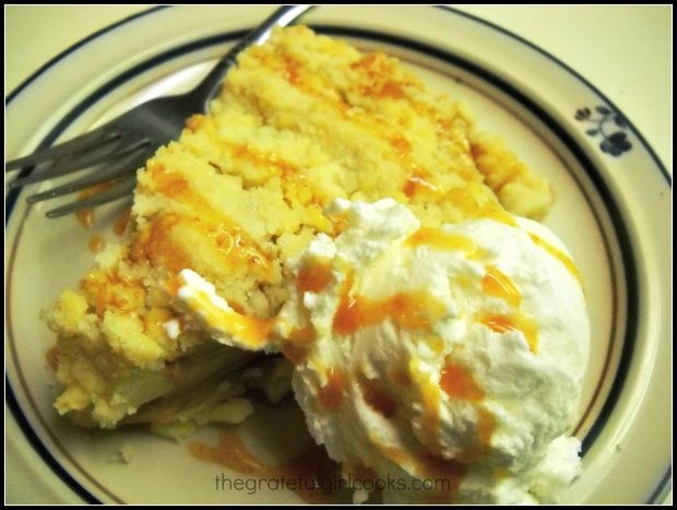 Slice of apple tart on plate with ice cream and caramel sauce