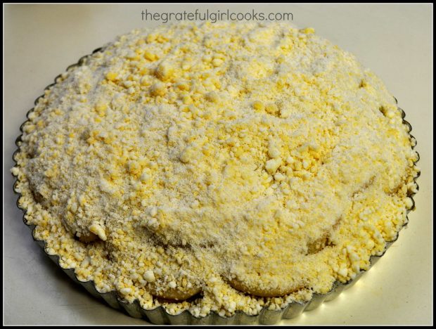 Streusel topping spread on apple shortbread tart