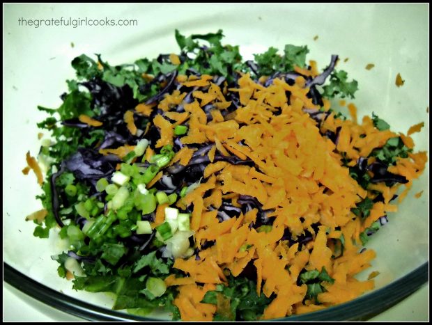 The ingredients for the Asian kale slaw in large mixing bowl.