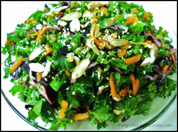 Kale slaw served with sliced almonds and sesame seeds as garnish.