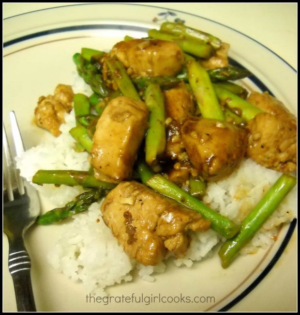 Chicken and Asparagus Stir Fry is served on a bed of white rice.