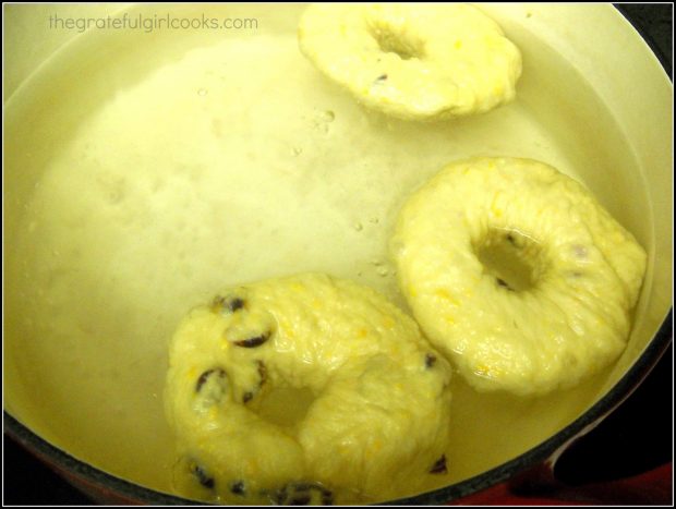 Cranberry orange bagels are cooked in boiling water before baking.