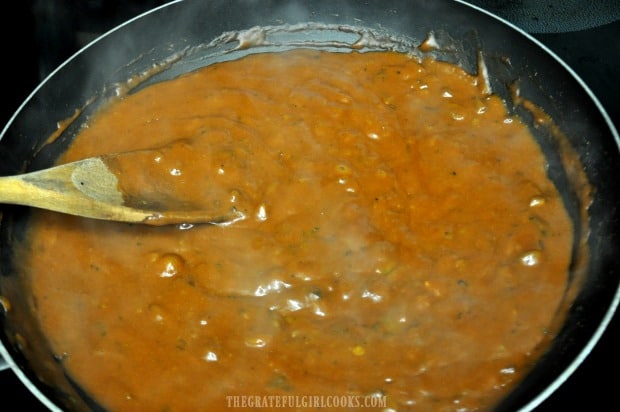Cooking the homemade mole sauce in a large skillet.