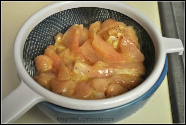 Chicken pieces for P.F. Chang's ginger chicken drains after marinating.