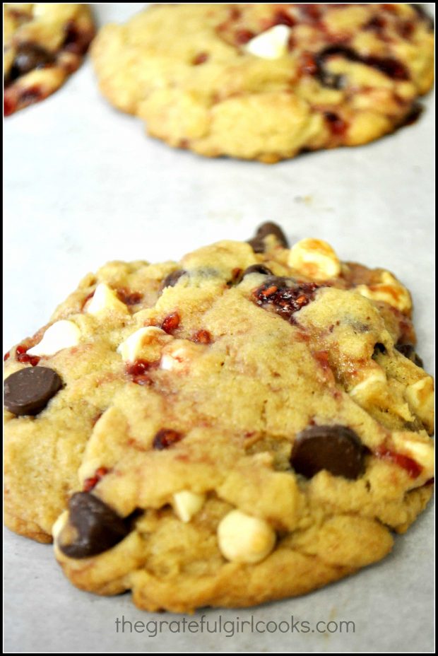 The baked white chocolate raspberry cookies are golden brown around edges.