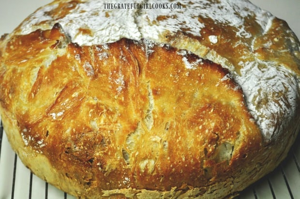 Loaf of no knead bread cooling on wire rack