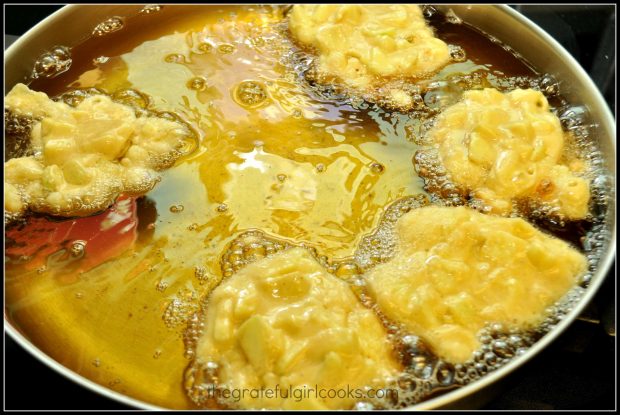 Dough being fried in oil in skillet