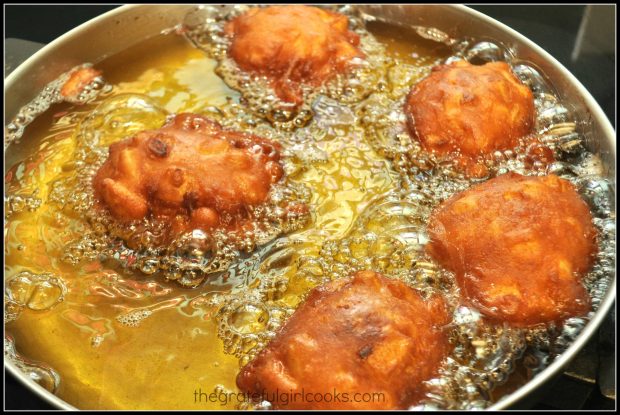 Golden brown Amish Apple Fritters in hot oil almost done