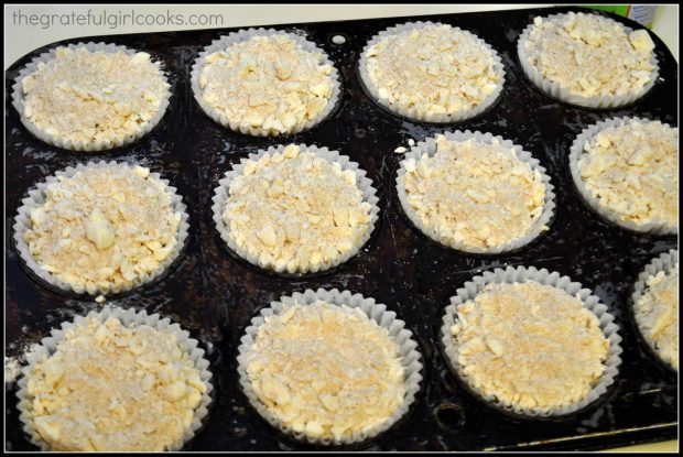 A streusel crumble topping is added to top of blueberry muffin batter.