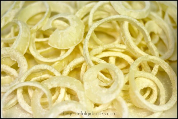 Sliced onions are tossed with flour before cooking.