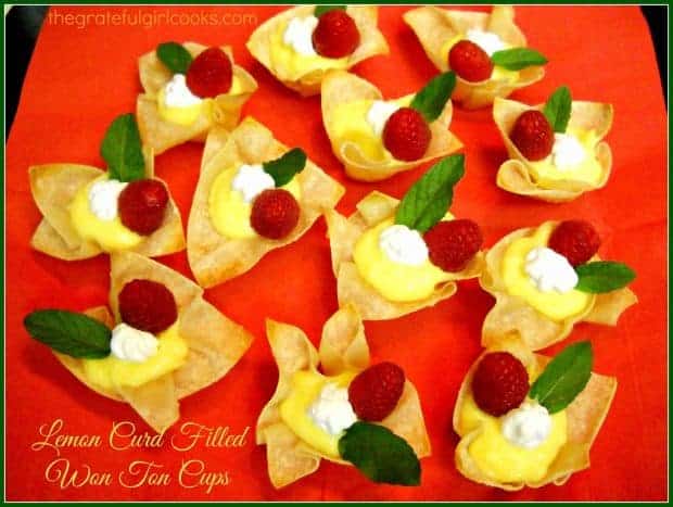 These tasty dessert bites, featuring filled lemon curd won ton cups, garnished with whipped cream, mint and a raspberry, will be a big hit!