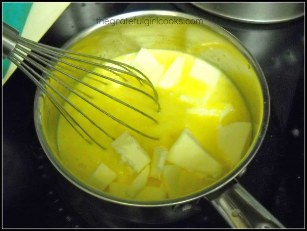 Butter added to lemon curd mixture in pan with whisk