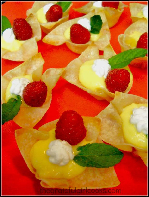 Lemon curd won ton cups, topped with raspberry, whipped cream and mint.