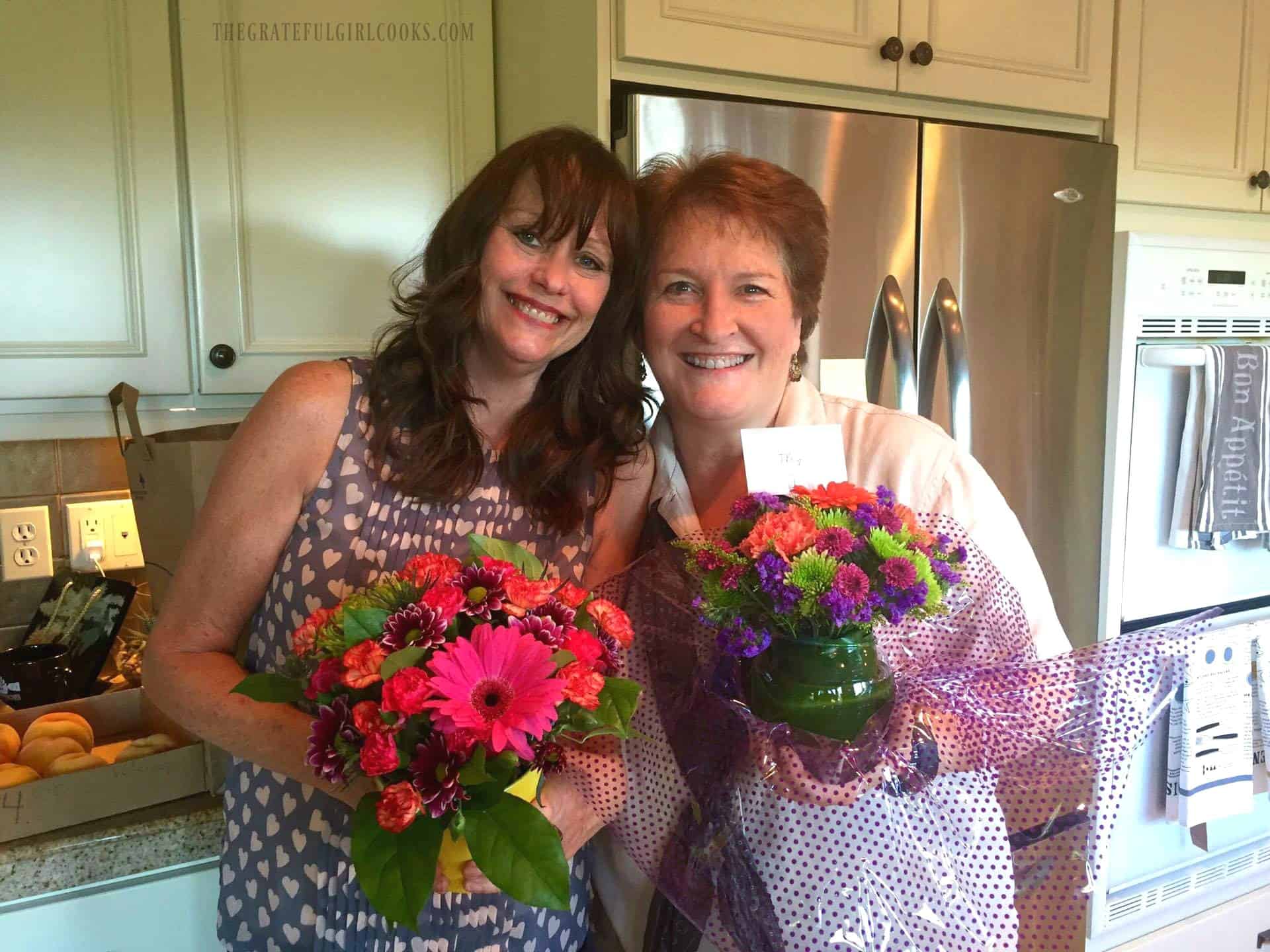 Two women, holding flowers