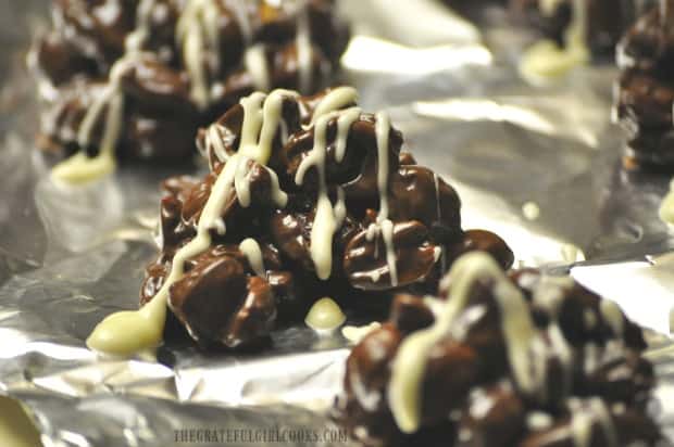 Chocolate butterscotch peanut clusters drizzled with icing.