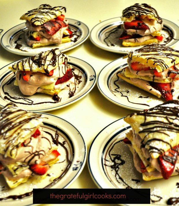 To serve, chocolate strawberry napoleons are dusted with powdered sugar and drizzled with chocolate.