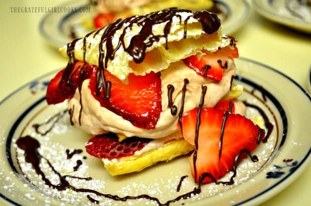 Close up photo of a chocolate strawberry napoleon on a serving plate.