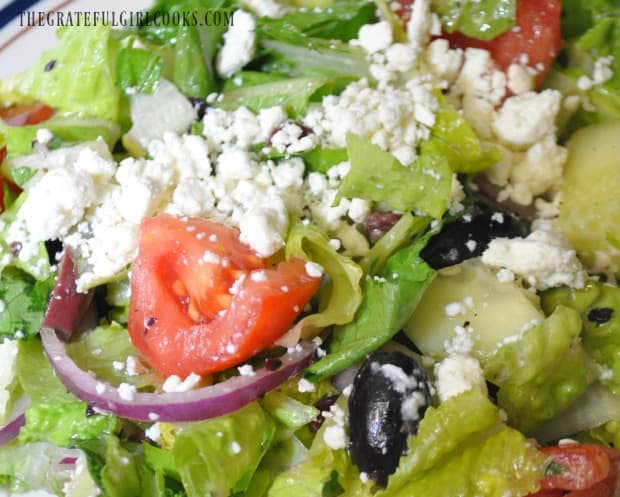 Greek salad, with red onions, tomatoes, cucumbers and kalamata olives.