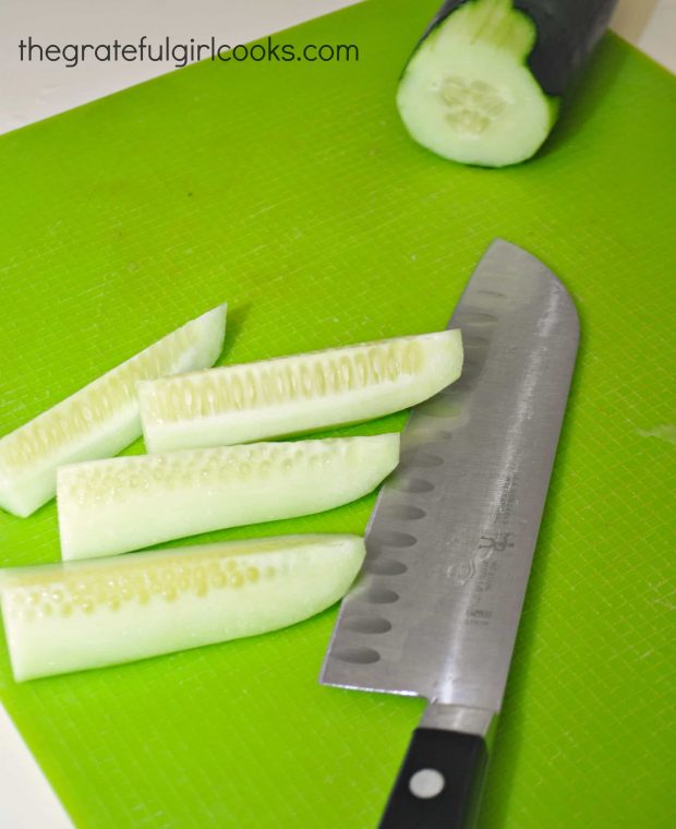 Peeled cucumbers are cut into wedges, then chunks, for the Greek salad.