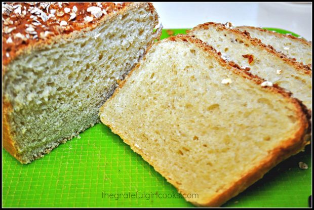 Slices cut from honey oat bread on green plastic mat