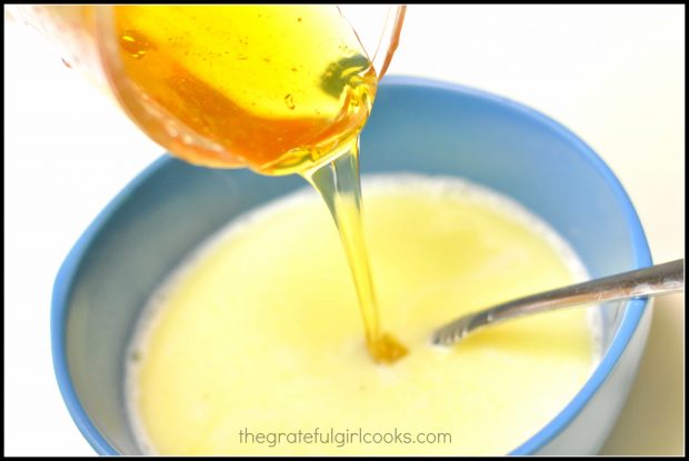 Honey added to butter mixture in blue bowl