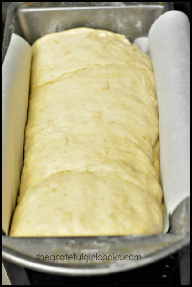 Honey Oat Bread dough is placed into loaf pan with parchment paper