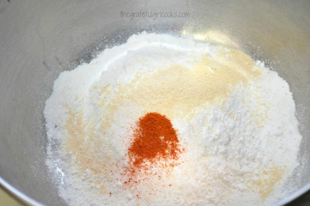 Biscuit mix and spices are combined in a mixing bowl.