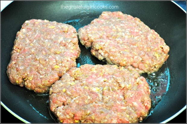 Salisbury steak patties are pan-seared in skillet.