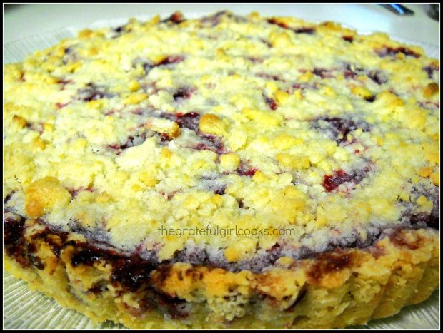 Baked boysenberry shortbread tart on serving platter