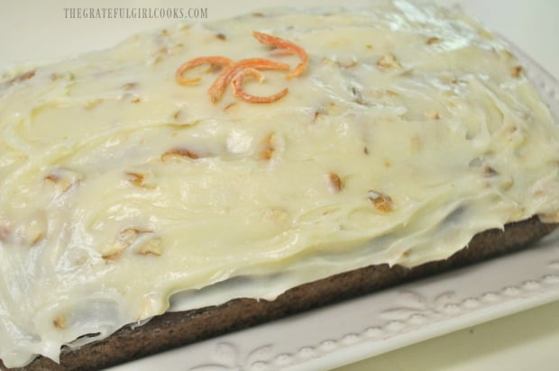 This loaf of carrot zucchini bread is frosted and ready to serve!