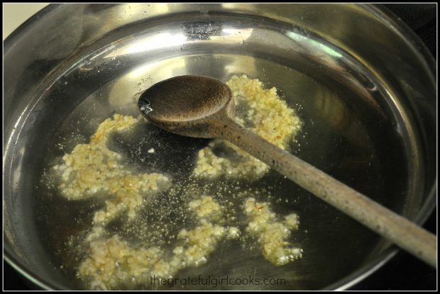 Minced garlic is cooked in hot olive oil.